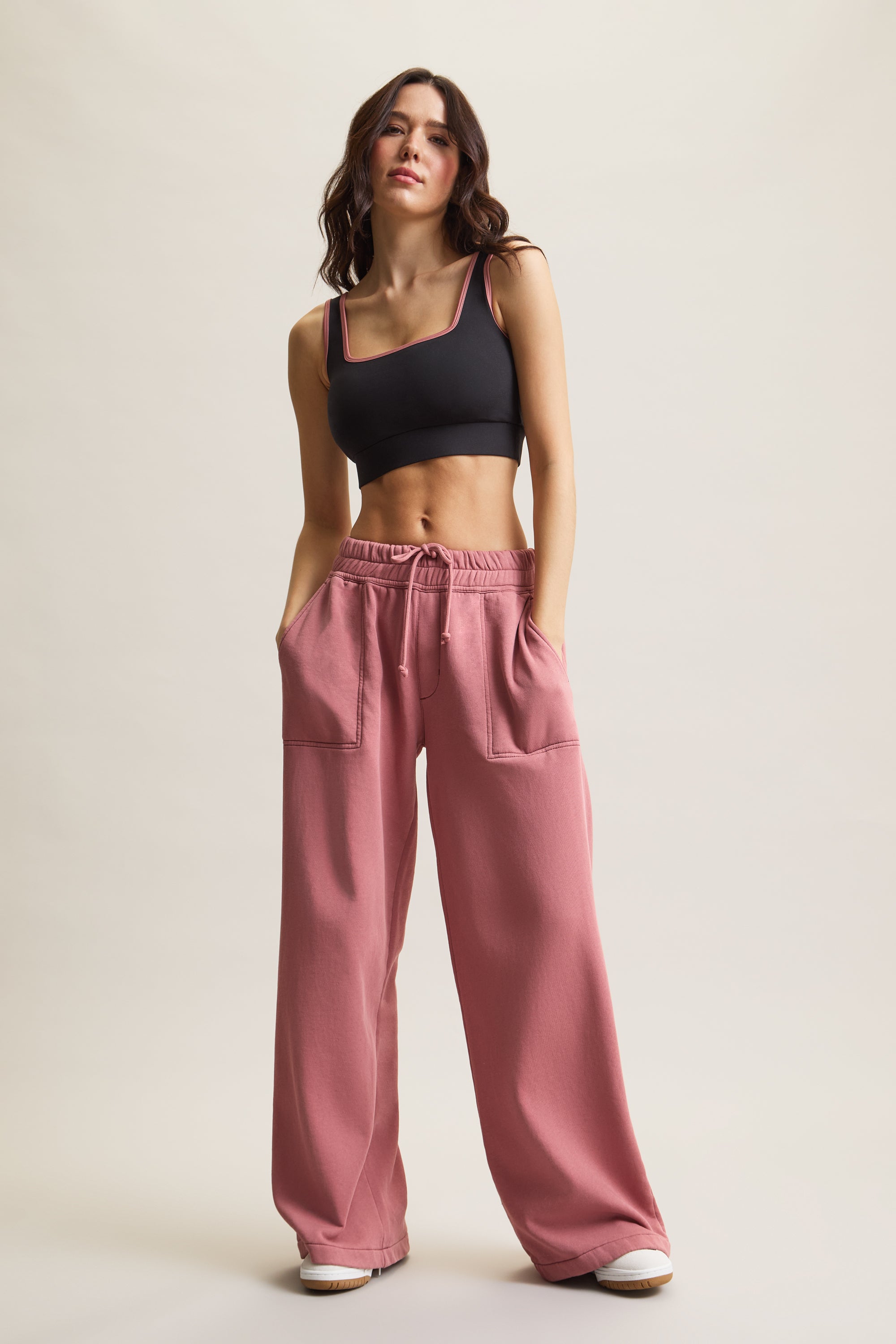 Women's HRMN8 dusty pink wide-leg joggers with adjustable drawstring waist, fleece lining, and side pockets and black cropped top