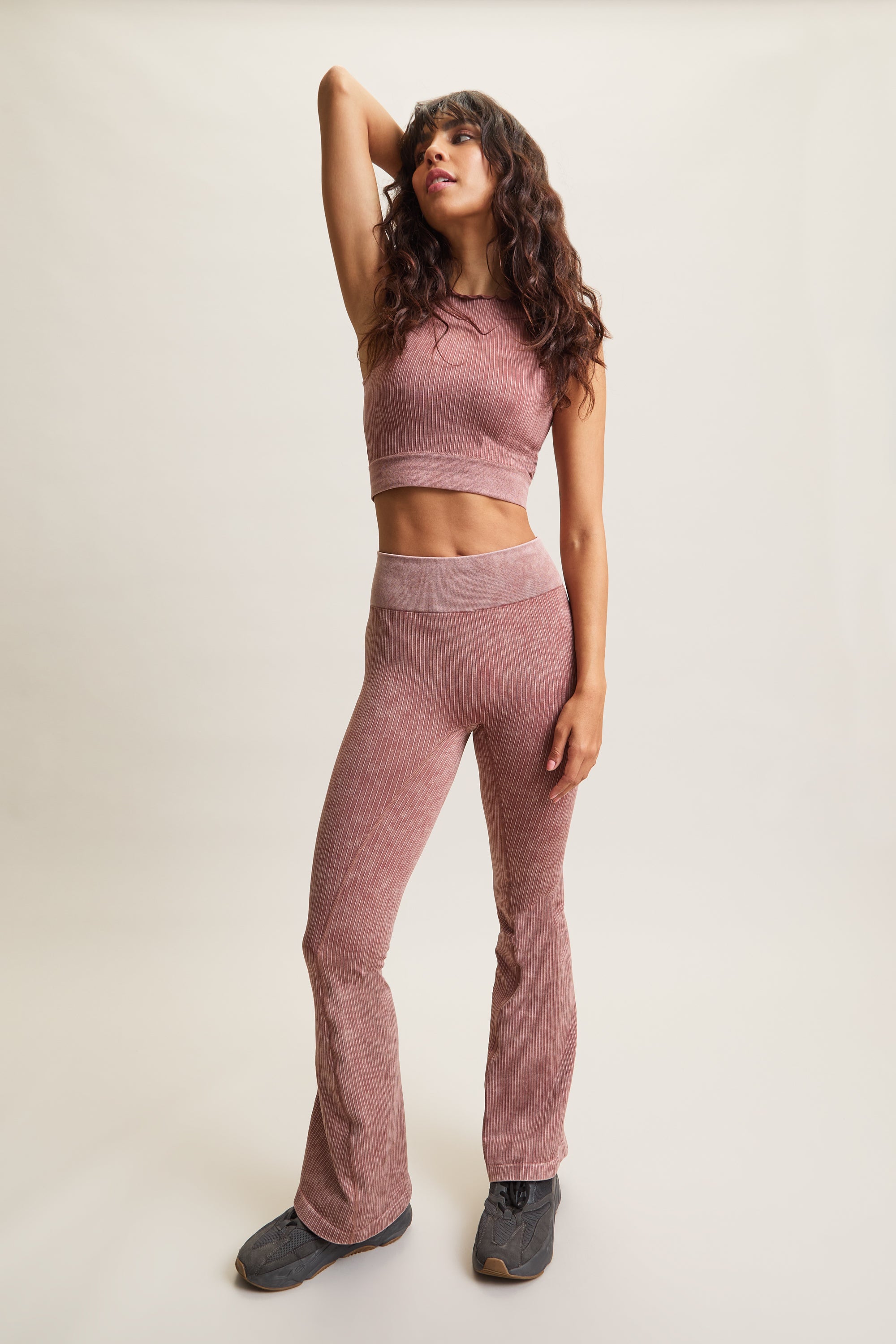 Women's HRMN8 pink orange Takeover Flare Ribbed Leggings in an acid wash finish, featuring rib pin detailing, seamless construction, and a high-waisted design for a sculpted fit. Flared hem for a modern, flattering silhouette. Designed for athleisure, casual styling, and effortless everyday wear. Pairs with the Takeover Ribbed Cropped Top for a coordinated set.
