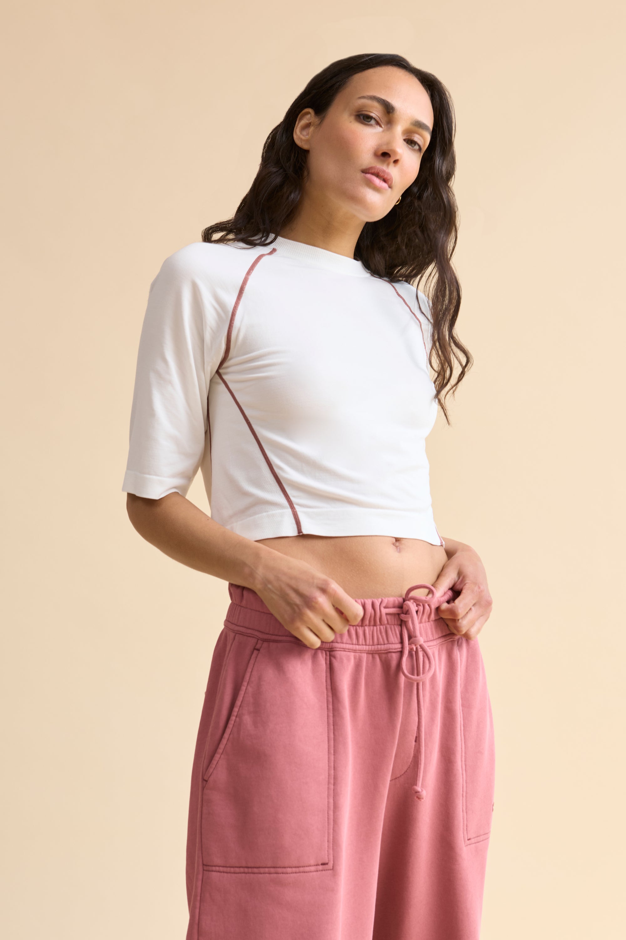 HRMN8 Women's white pink Reform Tee, seamless ultra-soft nylon with contrast stitching and sculpted athleisure fit.