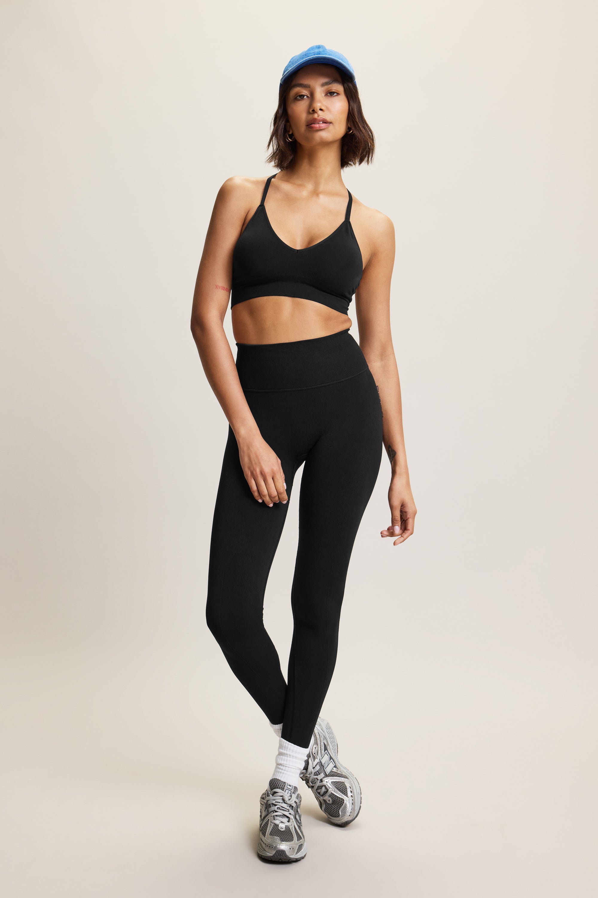 High-waisted black seamless sculpting leggings for women in eco-friendly fabric, perfect for athleisure, activewear, and yoga. Moisture-wicking and squat-proof design ideal for performance, workout, and fitness activities. Fashionable, figure-hugging leggings offering tummy control and breathable comfort, crafted from sustainable materials for versatile all-day wear.