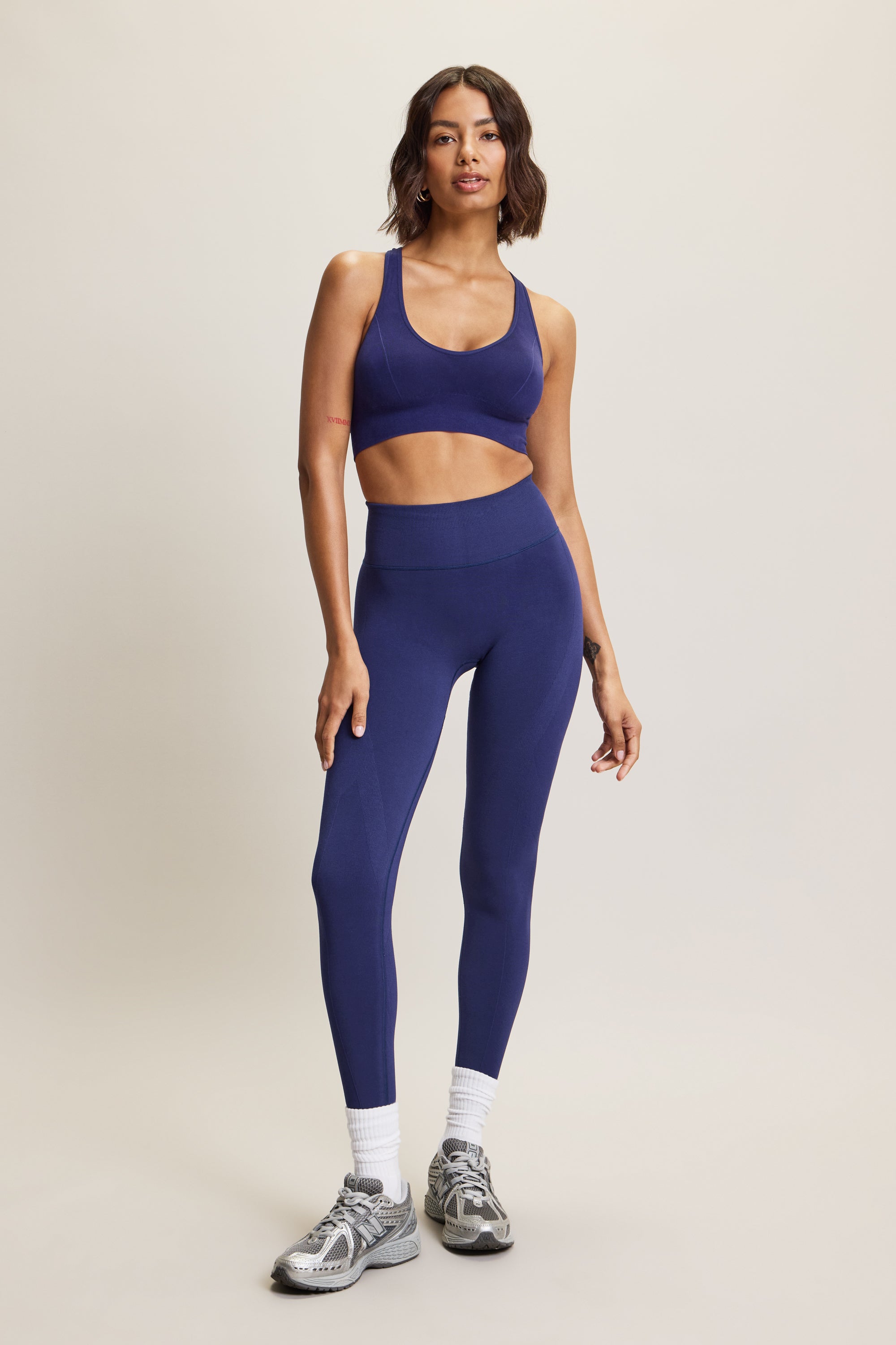 High-waisted navy seamless sculpting leggings for women in eco-friendly fabric, perfect for athleisure, activewear, and yoga. Moisture-wicking and squat-proof design ideal for performance, workout, and fitness activities. Fashionable, figure-hugging leggings offering tummy control and breathable comfort, crafted from sustainable materials for versatile all-day wear.