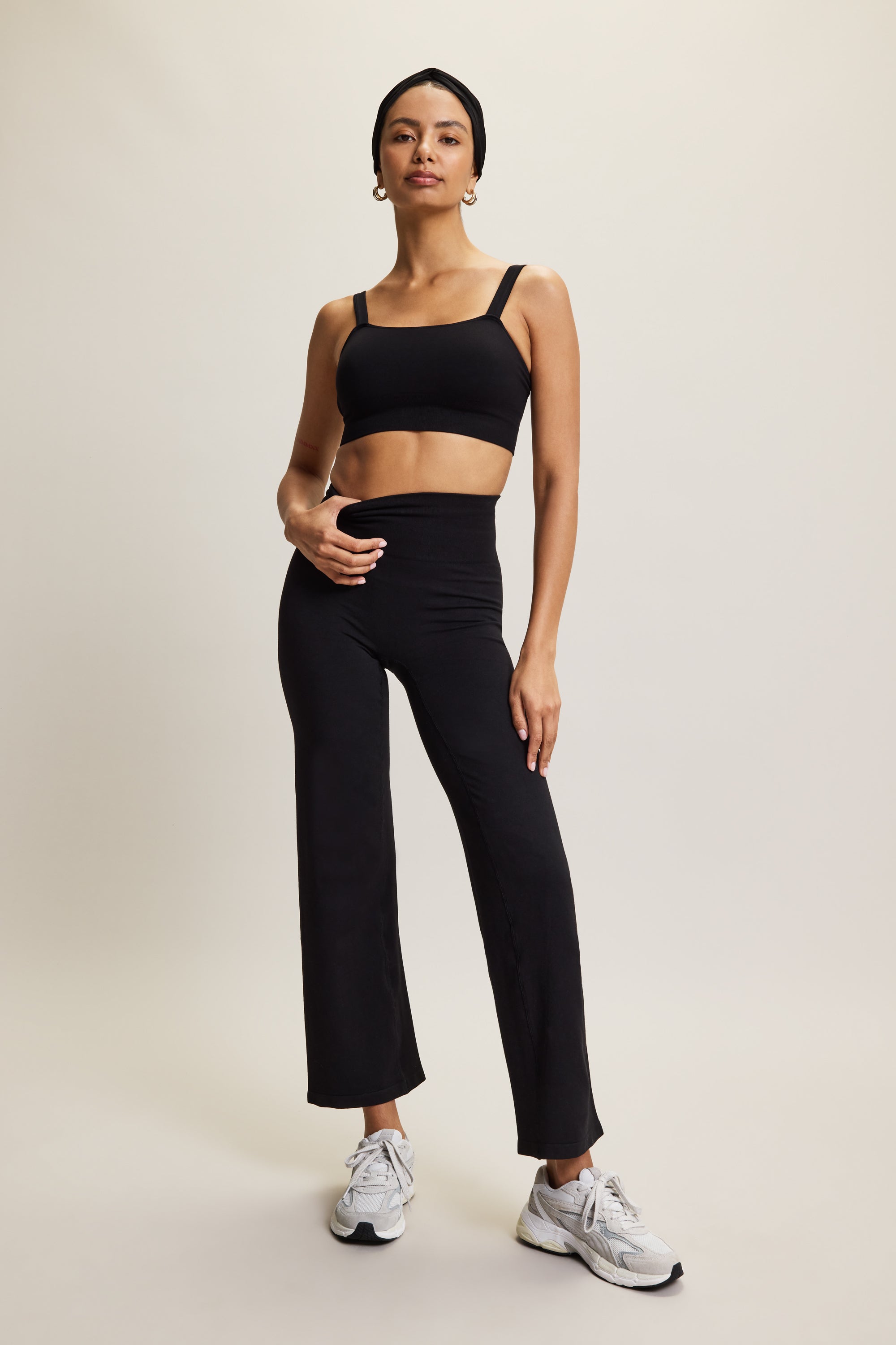 Premium wide leg bamboo black yoga trousers with a high-rise ribbed waistband in soft brown fabric, designed for yoga, Pilates, lounging, and versatile athleisure wear. These comfortable and breathable activewear pants offer a relaxed yet stylish fit, perfect for transitioning from studio to street or incorporating into an everyday wardrobe.