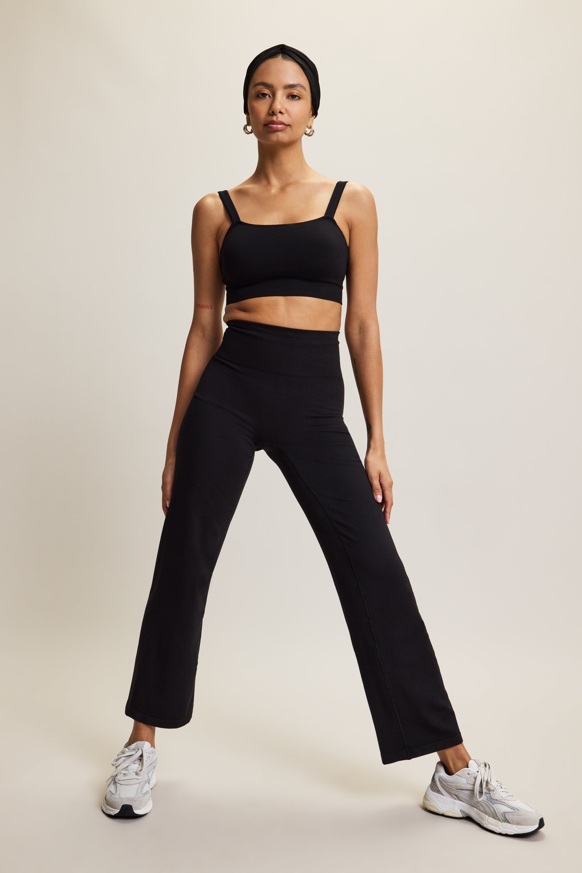 Premium wide leg bamboo black yoga trousers with a high-rise ribbed waistband in soft brown fabric, designed for yoga, Pilates, lounging, and versatile athleisure wear. These comfortable and breathable activewear pants offer a relaxed yet stylish fit, perfect for transitioning from studio to street or incorporating into an everyday wardrobe.