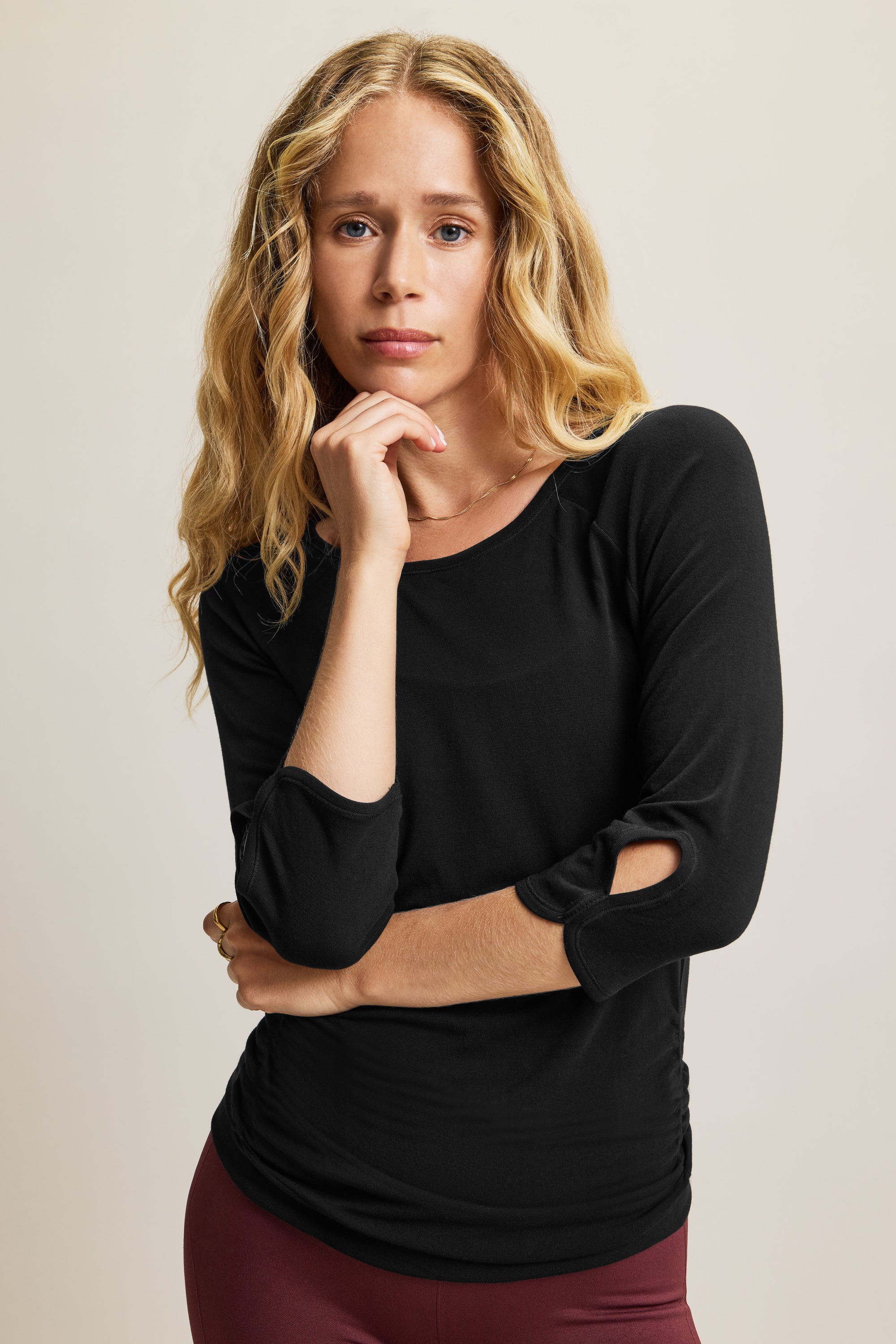 Black soft bamboo 3/4 sleeve performance round neck top with side ruching for yoga, pilates, running and exercise.