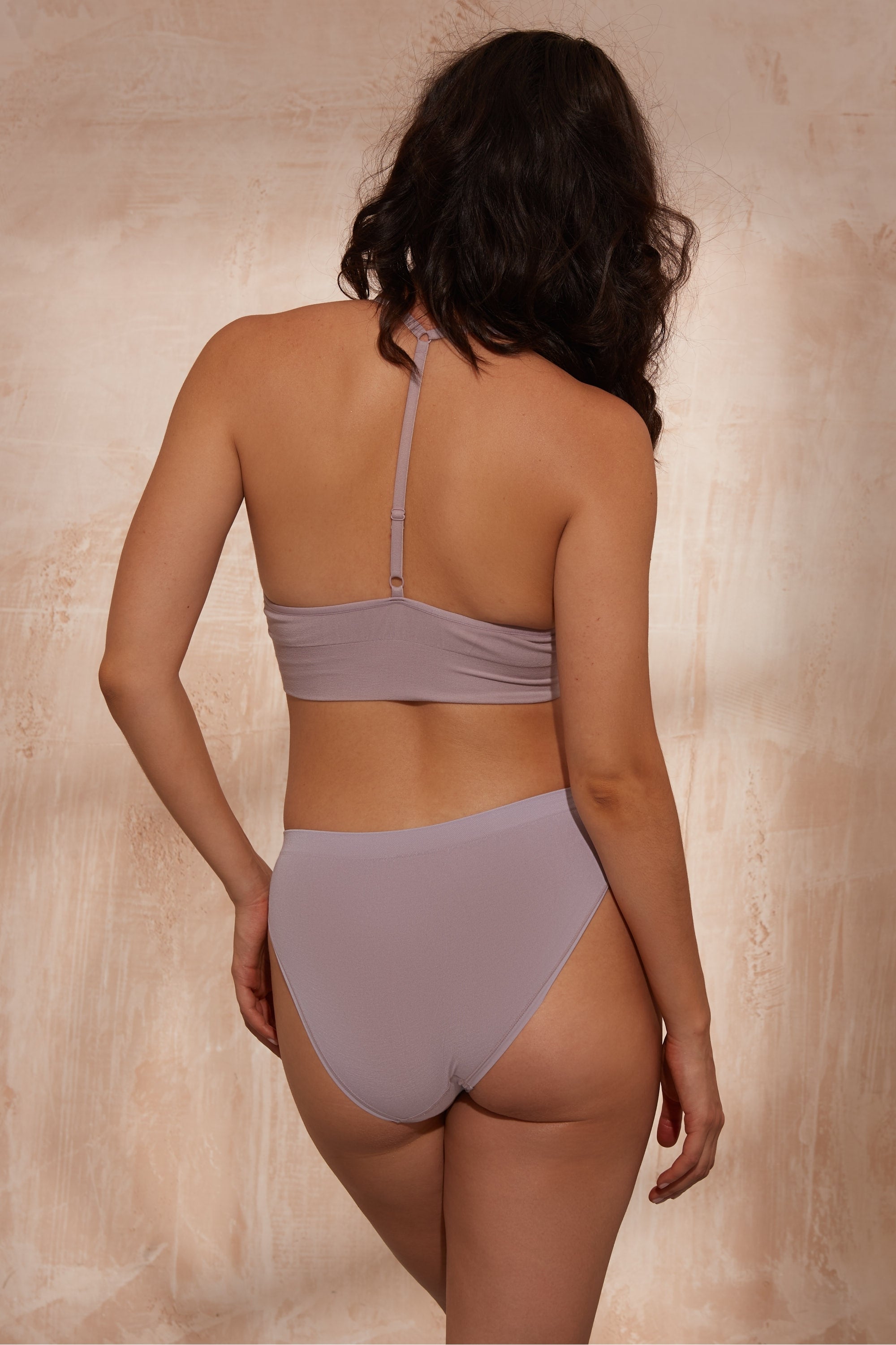 Model wearing lilac top and lilac briefs.